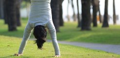 Young woman practice handstand on park meadow Young woman practice handstand on park meadow